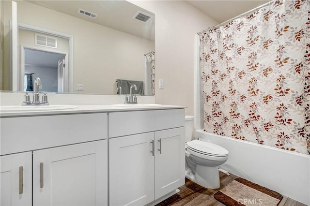 full bathroom with toilet, wood-type flooring, vanity, and shower / tub combo with curtain