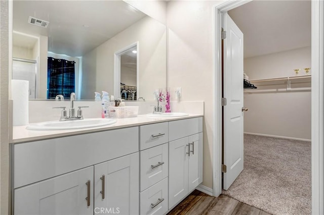 bathroom with vanity and hardwood / wood-style flooring