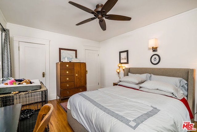 bedroom with hardwood / wood-style floors and ceiling fan