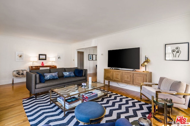 living room featuring ornamental molding and light hardwood / wood-style flooring