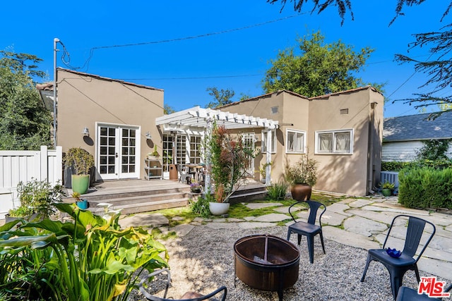 back of house with a patio, french doors, a pergola, central AC unit, and an outdoor fire pit