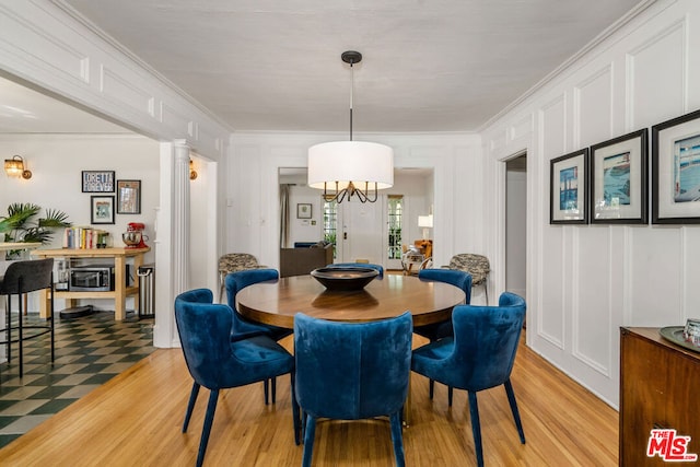 tiled dining space with ornate columns and ornamental molding