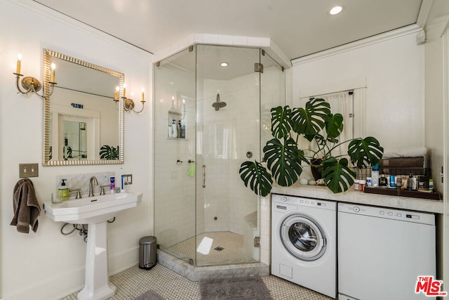 laundry room featuring separate washer and dryer, crown molding, and light tile floors