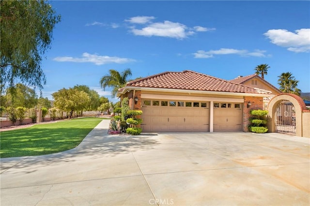 mediterranean / spanish-style home featuring a garage and a front lawn