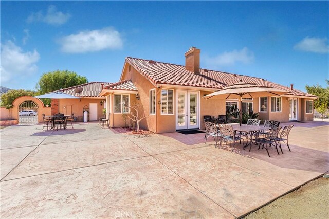 rear view of house featuring french doors and a patio