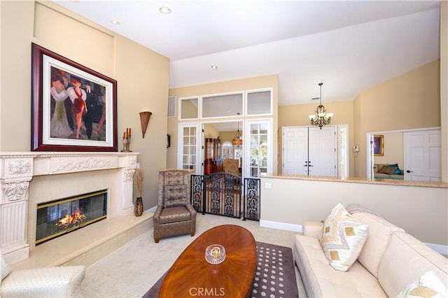 living room featuring light carpet, a fireplace, and a notable chandelier