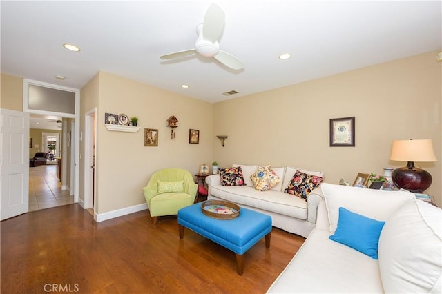 living room featuring hardwood / wood-style floors and ceiling fan