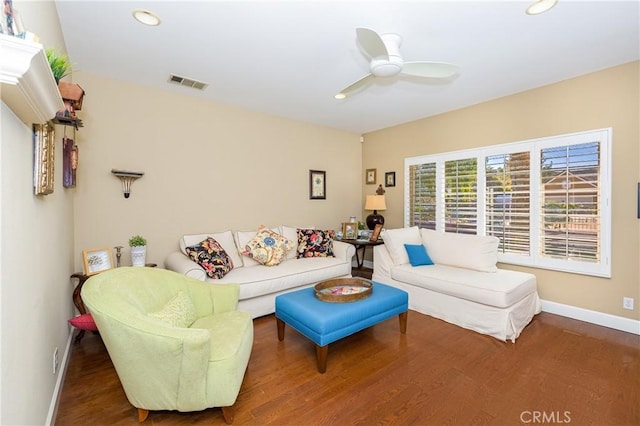 living room featuring hardwood / wood-style floors and ceiling fan