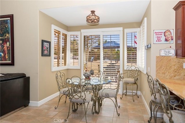 dining area featuring light tile patterned floors