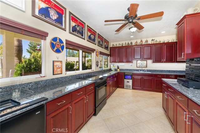 kitchen with ceiling fan, sink, dark stone countertops, a textured ceiling, and black appliances