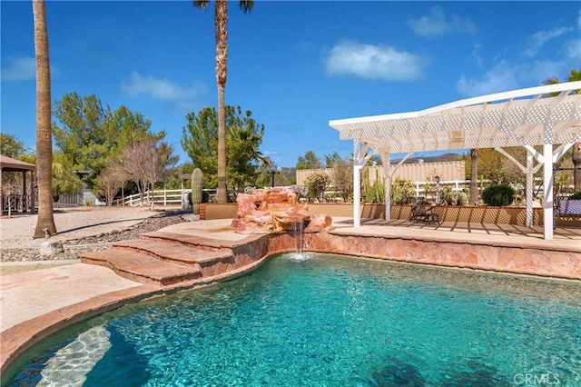 view of swimming pool with a pergola, pool water feature, and a patio area