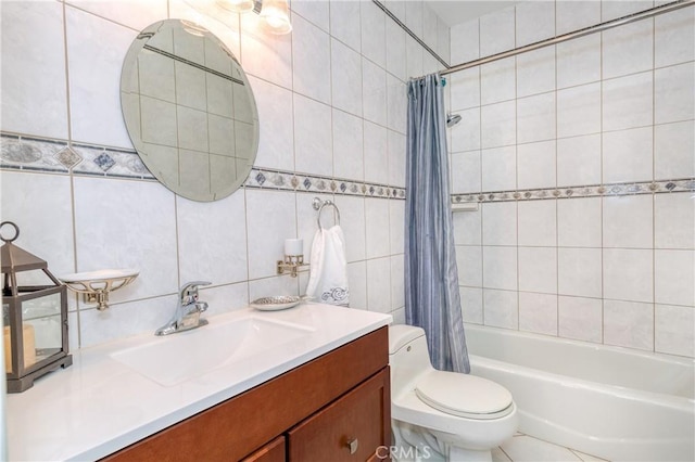 full bathroom featuring shower / bath combo, vanity, tile patterned floors, toilet, and tile walls