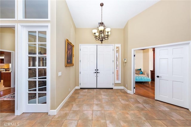 tiled entryway with an inviting chandelier