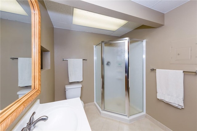 bathroom with sink, a shower with shower door, and toilet