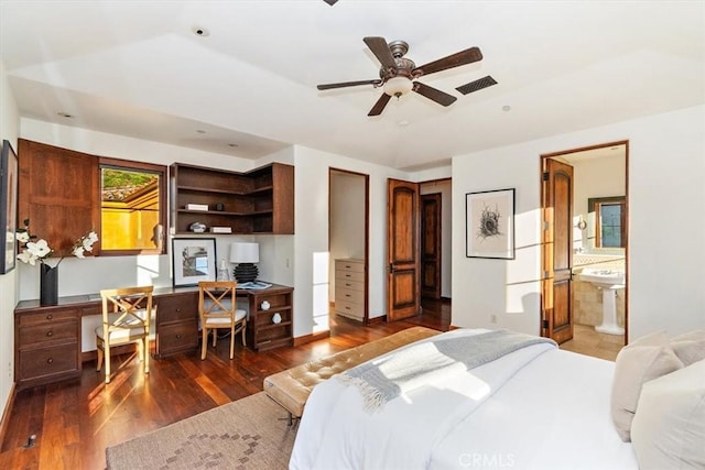 bedroom with ensuite bath, ceiling fan, and dark wood-type flooring