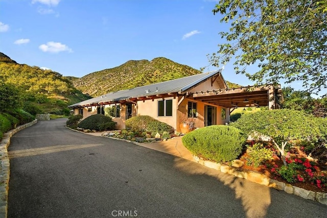 view of front of property with a carport and a mountain view