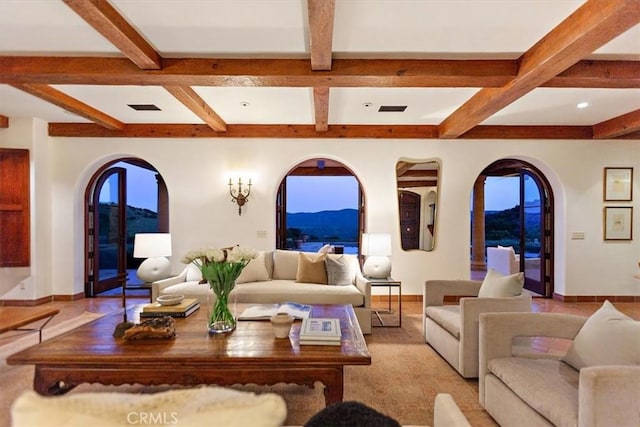 living room with a mountain view, beam ceiling, and coffered ceiling