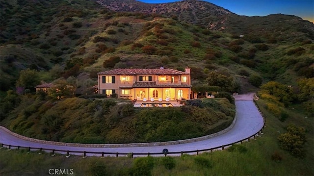 rear view of house featuring a mountain view