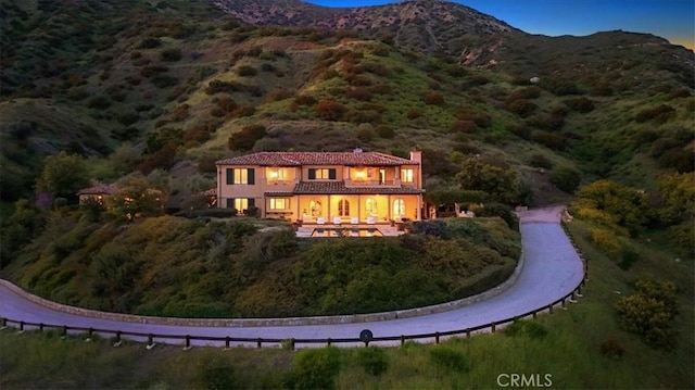 2835 Hermitage Rd, Ojai, CA 93023 - rear view of house with a chimney, stucco siding, a balcony, a tiled roof, and a mountain view