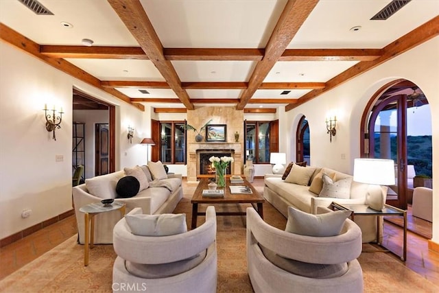 living room with french doors, coffered ceiling, beam ceiling, a fireplace, and light tile patterned flooring