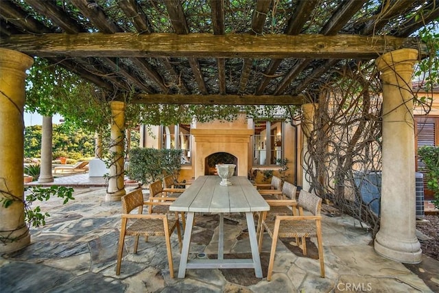 view of patio / terrace featuring an outdoor fireplace