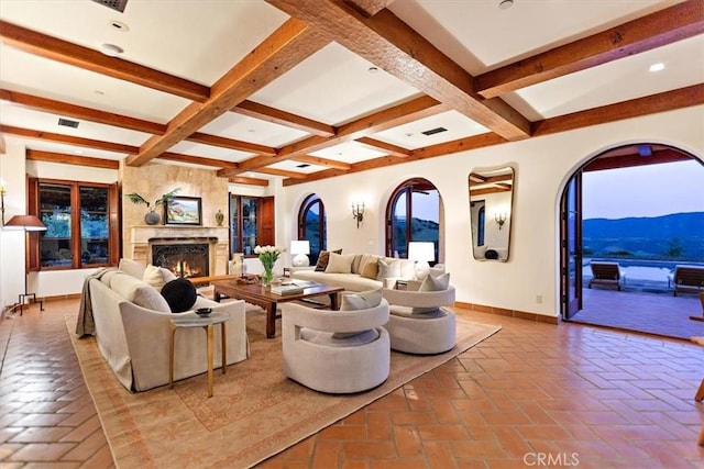 living room with a mountain view, plenty of natural light, beamed ceiling, and coffered ceiling