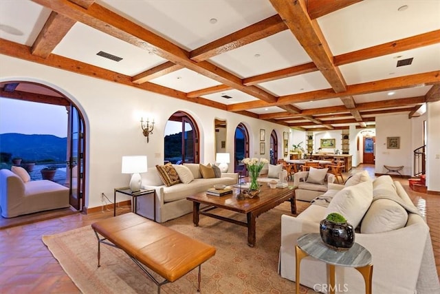 2835 Hermitage Rd, Ojai, CA 93023 - living area featuring visible vents, beamed ceiling, arched walkways, a mountain view, and coffered ceiling