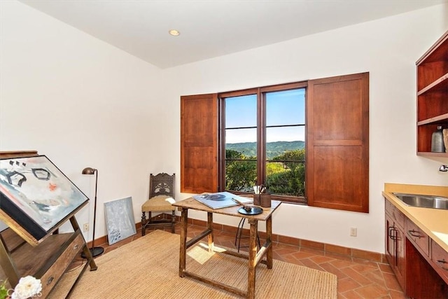 home office featuring light tile patterned floors and sink