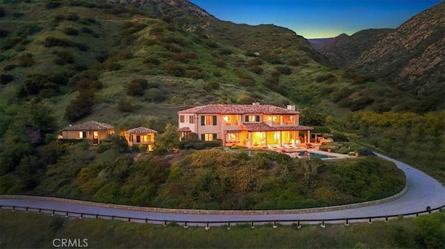 back house at dusk with a mountain view