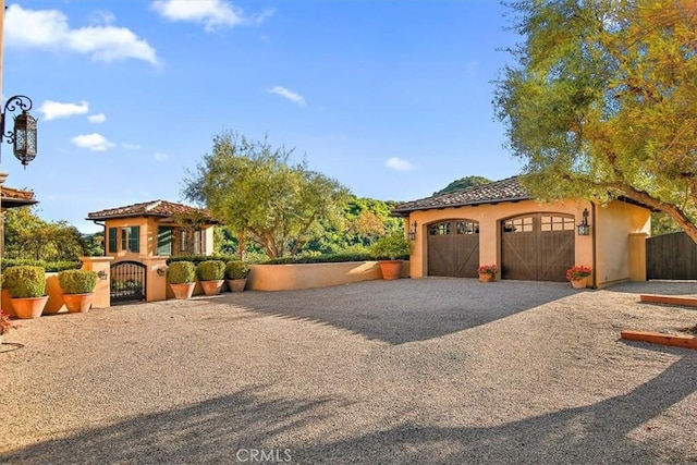 mediterranean / spanish-style home featuring a garage