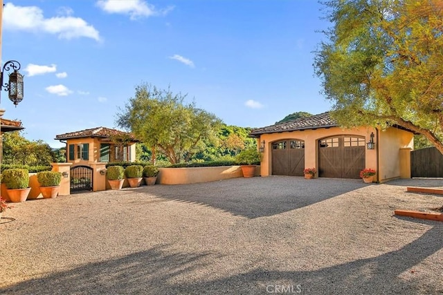 2835 Hermitage Rd, Ojai, CA 93023 - mediterranean / spanish-style house with driveway, a gate, stucco siding, fence, and a garage
