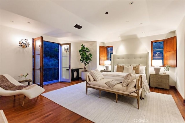 bedroom featuring hardwood / wood-style flooring and access to outside