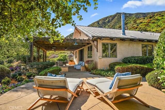 view of patio with a mountain view and a pergola