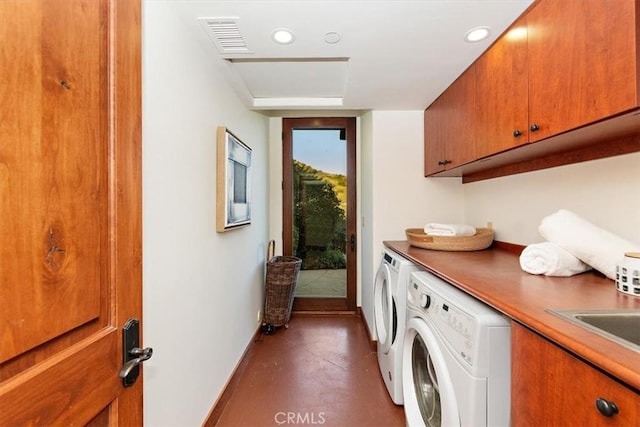 laundry area featuring cabinets and separate washer and dryer