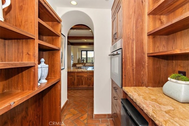 interior space featuring light stone countertops and appliances with stainless steel finishes