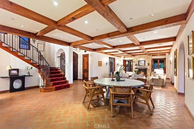 2835 Hermitage Rd, Ojai, CA 93023 - dining room with arched walkways, beam ceiling, baseboards, and stairs