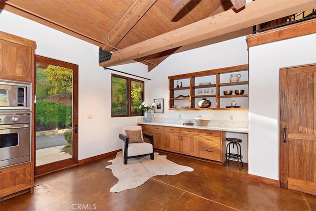 kitchen with vaulted ceiling with beams, wood ceiling, and appliances with stainless steel finishes