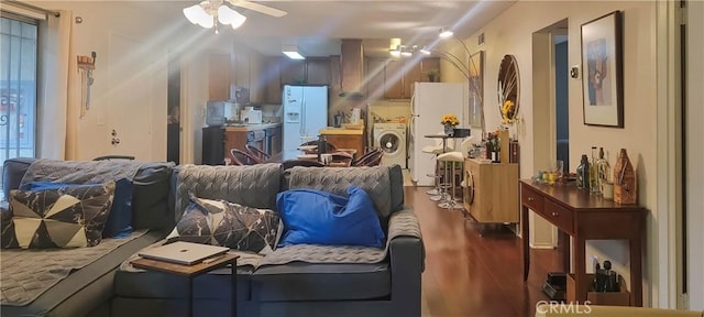 interior space with ceiling fan, hardwood / wood-style flooring, and independent washer and dryer