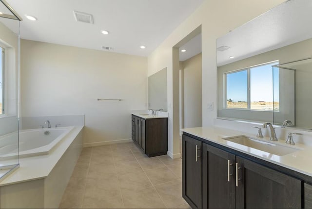 bathroom with vanity, tile patterned flooring, and a tub