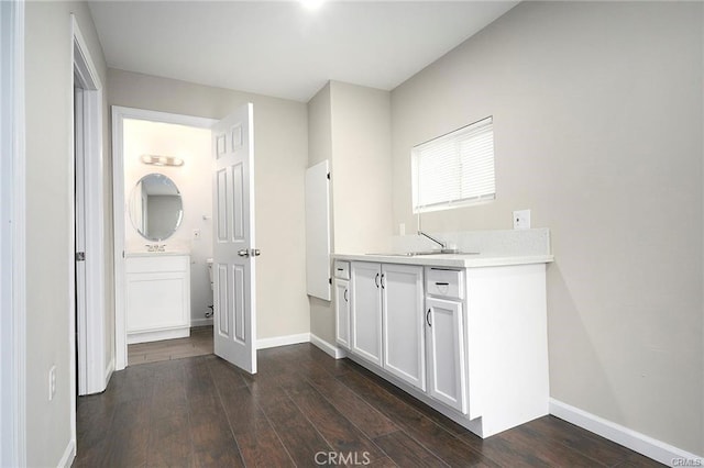 6454 Goleta Ave, Yucca Valley, CA 92284 - washroom featuring a sink, dark wood-style floors, and baseboards