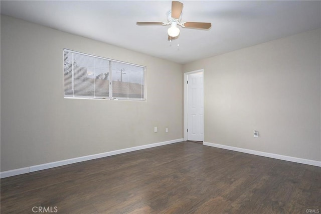 empty room featuring ceiling fan and dark wood-type flooring