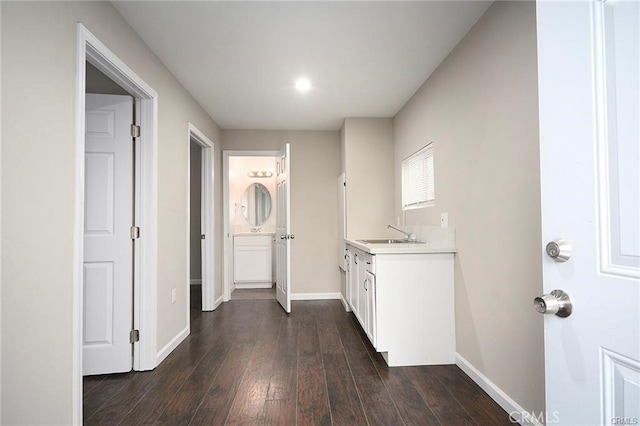 kitchen with white cabinetry, sink, and dark hardwood / wood-style floors