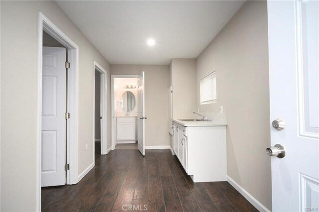 6454 Goleta Ave, Yucca Valley, CA 92284 - washroom with baseboards, dark wood-type flooring, and a sink