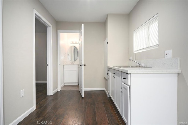 6454 Goleta Ave, Yucca Valley, CA 92284 - interior space featuring a sink, baseboards, and dark wood-style flooring