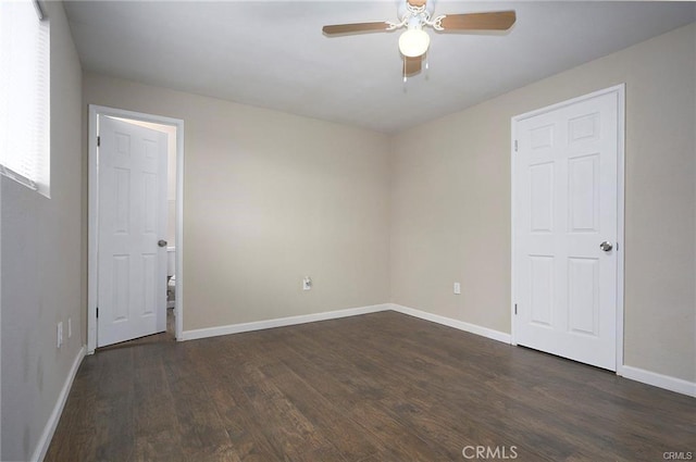 spare room featuring dark hardwood / wood-style floors and ceiling fan