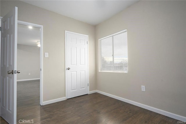 unfurnished bedroom featuring dark hardwood / wood-style flooring