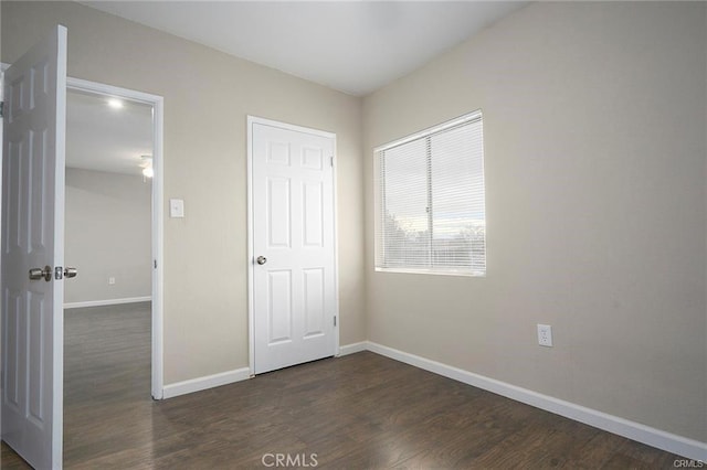6454 Goleta Ave, Yucca Valley, CA 92284 - unfurnished bedroom with baseboards and dark wood-style floors