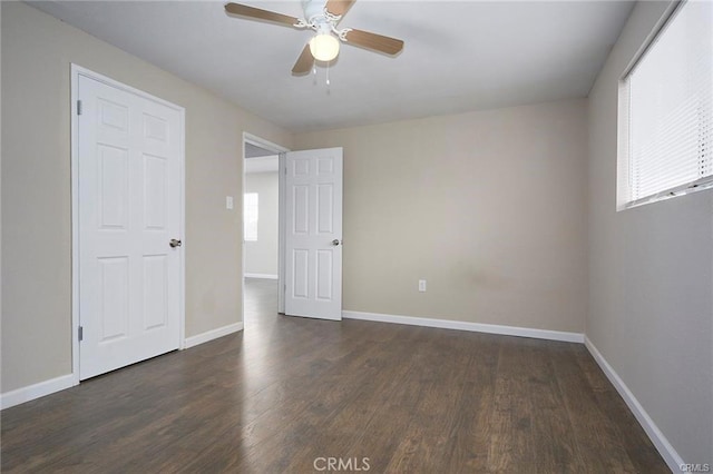 6454 Goleta Ave, Yucca Valley, CA 92284 - unfurnished bedroom featuring multiple windows, wood finished floors, and baseboards