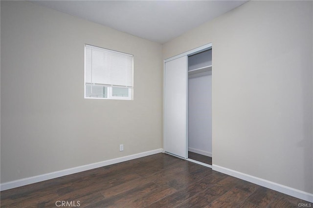 6454 Goleta Ave, Yucca Valley, CA 92284 - unfurnished bedroom with dark wood finished floors, baseboards, and a closet