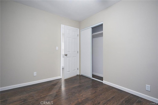 6454 Goleta Ave, Yucca Valley, CA 92284 - unfurnished bedroom with baseboards, dark wood finished floors, and a closet